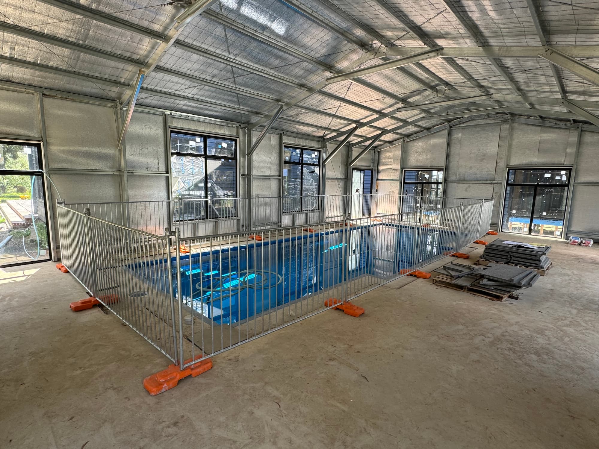 Temporary fencing around an inside swimming pool